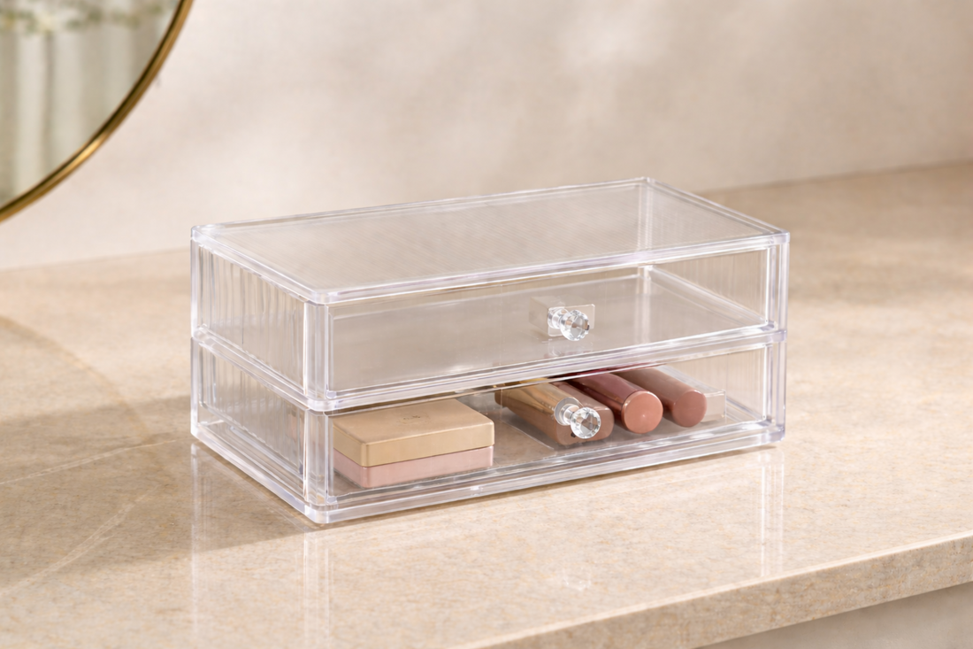 Clear drawer organizer with separated sections and minimal makeup items arranged for structured visibility.