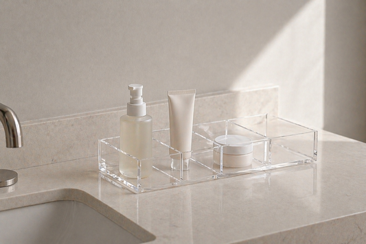 Clean bathroom vanity with a structured organizer holding three items in clearly separated compartments.