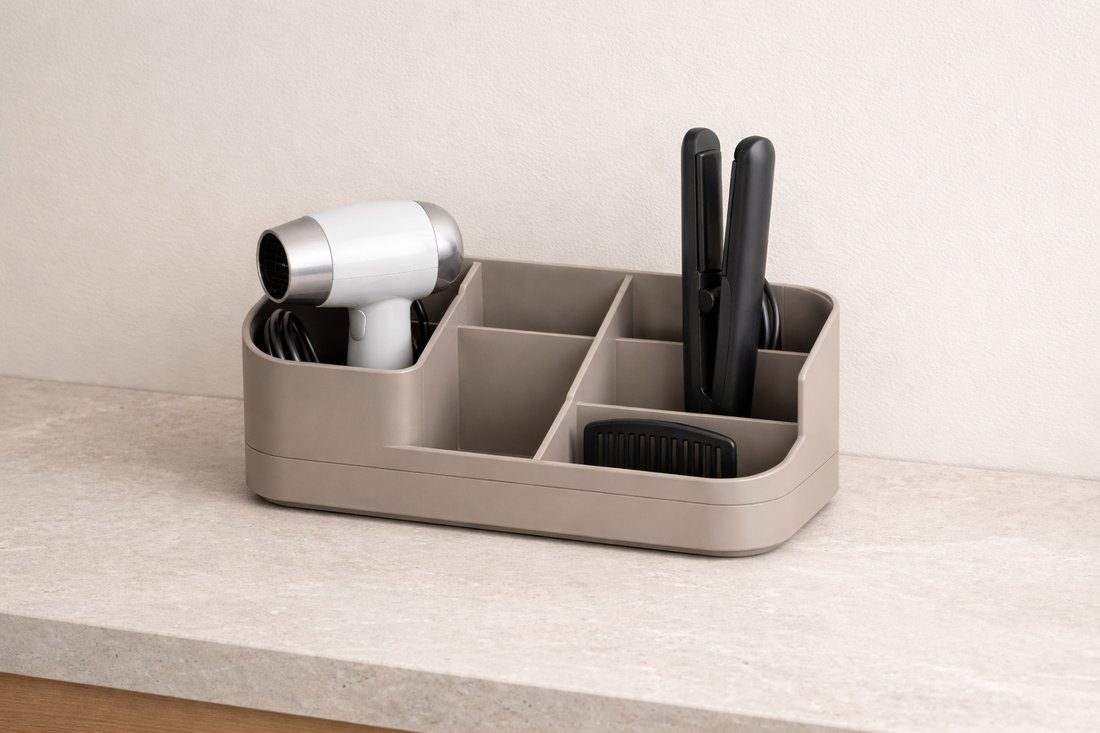 Bathroom vanity organizer separating hair tools with clear sections and untangled cords for easy access.
