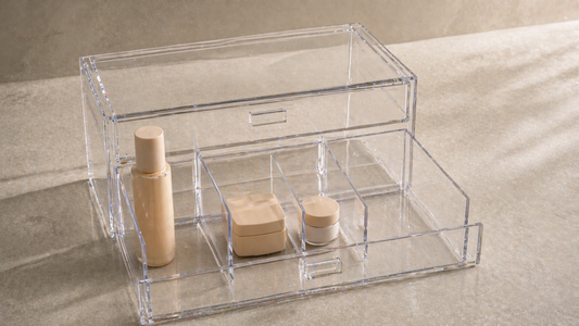 Adjustable acrylic drawer with uneven compartments fitting tall, medium, and small items for flexible storage.
