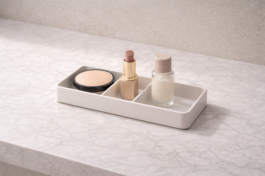 Compact makeup organizer with three items placed in separate compartments and one empty section showing efficient single-step access