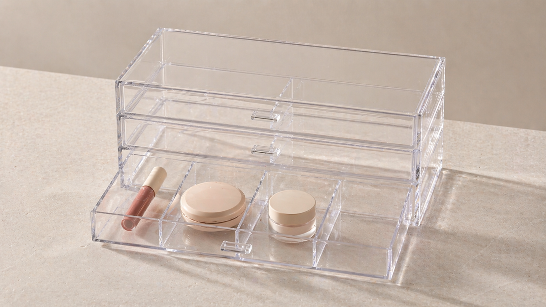 Minimal clear acrylic drawer organizer with items separated by category and one empty space, showing an efficient layout that needs no additional items.