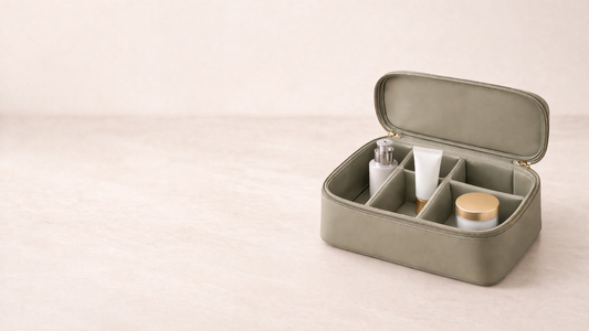 Premium travel makeup organizer with bottle, tube, and jar arranged in separated compartments for efficient packing.