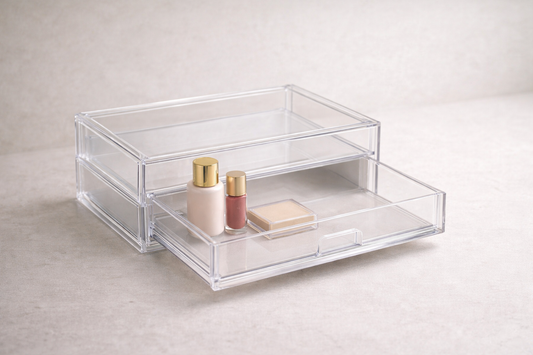 Compact acrylic drawer organizer with three daily makeup items and visible empty space.