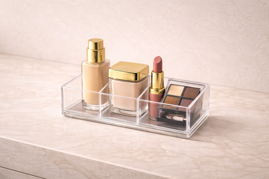 Clear acrylic makeup organizer showing 4 items arranged closely in separate compartments, demonstrating compact grouping with full visibility and easy access.