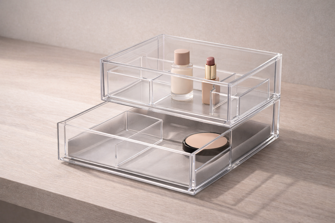 Clear acrylic drawer organizer with visible dividers and layered compartments showing structured depth control