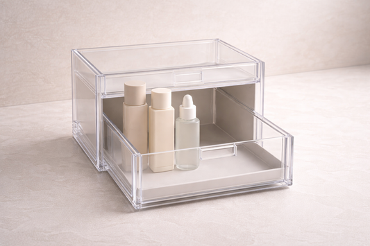 Deep acrylic drawer with tall bottles stored upright in one section and empty space on the other side to maximize vertical storage.