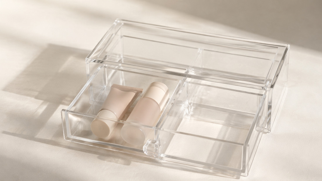Clear acrylic drawer organizer showing one section used and adjacent compartments empty for structured separation