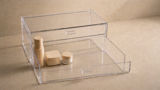 Acrylic drawer with a tight item cluster on one side and open space elsewhere to support faster, repeatable routine flow.