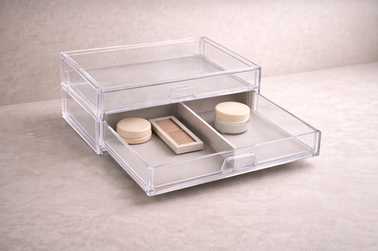 Acrylic drawer organizer with makeup items on one side and skincare on the other, showing clear section division and balanced spacing.