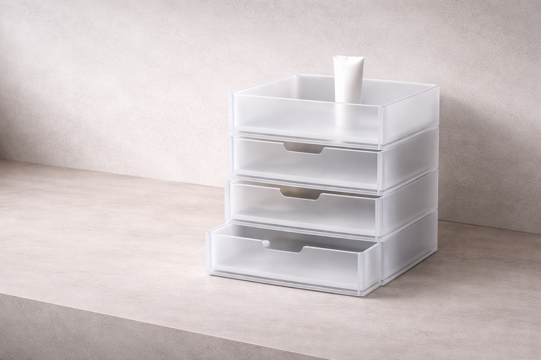 Drawer setup for easy access that improves daily speed featuring frosted white stacked storage drawers with a minimalist skincare tube on a neutral surface
