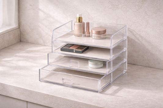 Efficient makeup storage for faster daily routines featuring clear acrylic drawers with a foundation bottle and makeup palette on a vanity