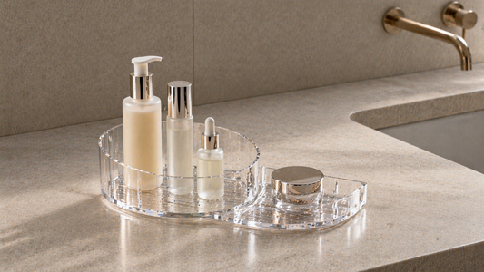 Acrylic organizer with clustered primary items and a separated secondary item to reduce reach movement.
