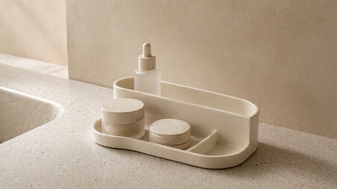 Minimal vanity organizer with fixed item placement in front reach zones and one empty section, forming a stable layout that remains effortless over time.