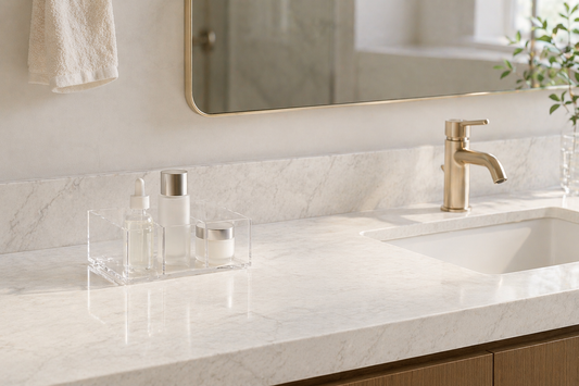 Vanity surface with large empty space and a minimal acrylic organizer holding few items.