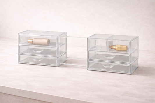 Expandable acrylic drawer system with two connected sections sliding apart to adjust width and fit changing storage needs