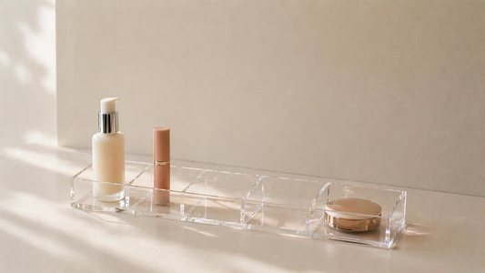 Minimal acrylic makeup organizer with three items spaced for immediate use and clear empty compartment.
