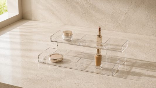 Layered makeup organizer with separated product categories and open spacing.