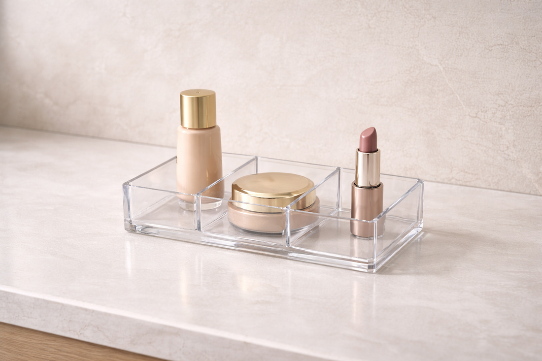 Three makeup items placed in separate compartments of a clear organizer for unobstructed single-motion access