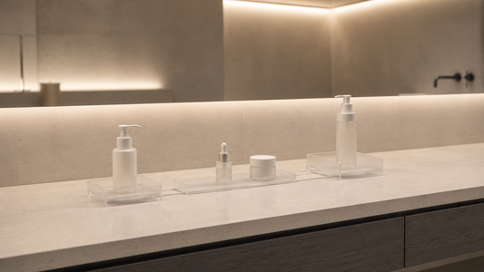 Minimal bathroom vanity organizer with floating tray spacing and low density skincare layout.