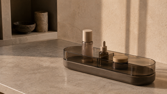 Smoked resin daily routine organizer with separated skincare products and calm structured spacing.