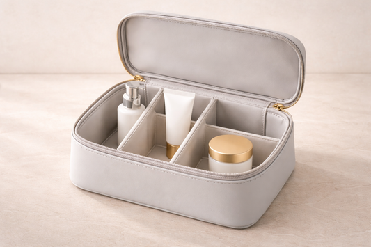 Neutral gray travel cosmetic organizer with internal dividers and 3 items spaced clearly for fast access and structured separation.
