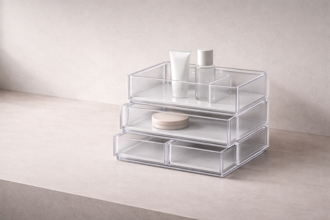 Quick drawer organization that improves everyday usability featuring clear stacked storage drawers with beauty products on a minimalist surface