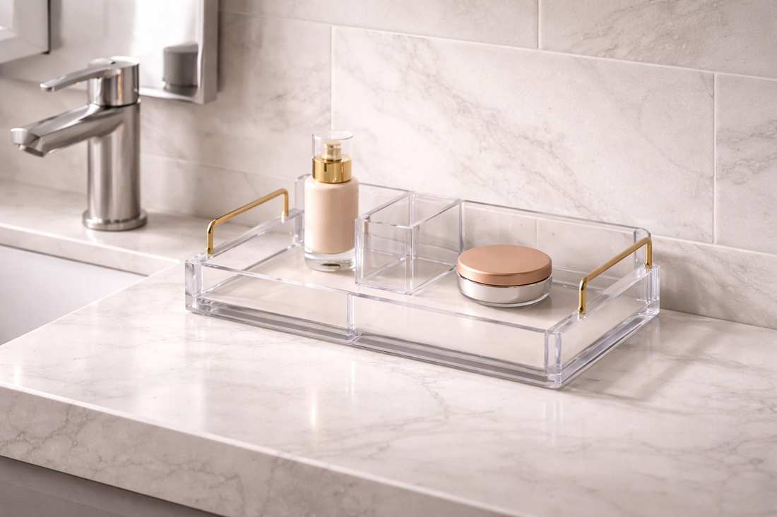 Quick vanity organization for cleaner daily routines featuring a clear acrylic tray with gold handles holding skincare and makeup on a marble countertop