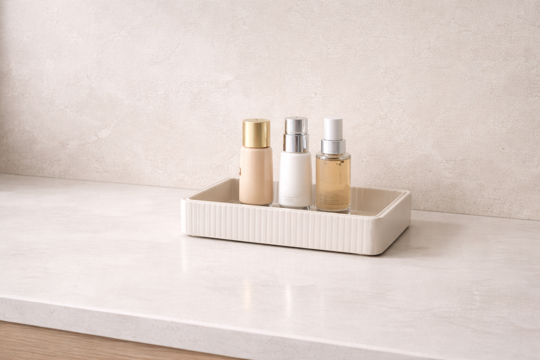 Three skincare bottles grouped closely in a single tray with clear surrounding empty space for faster daily access