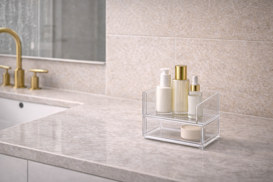 Skincare products placed in an organizer away from direct moisture on a bathroom counter.
