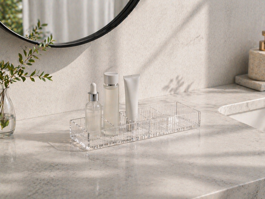 minimal skincare organization with clear acrylic organizer partially filled with 3 items arranged in separated zones for limited bathroom space efficiency