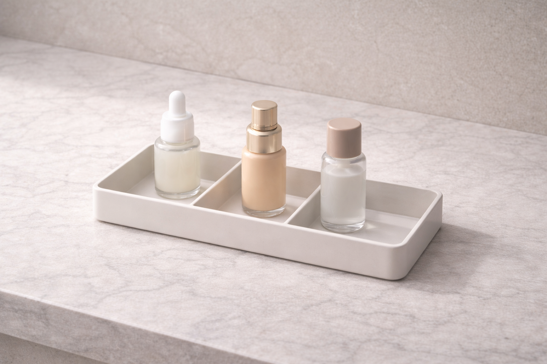 Three skincare bottles placed in separate compartments with visible gaps and one empty section showing airflow spacing and stability