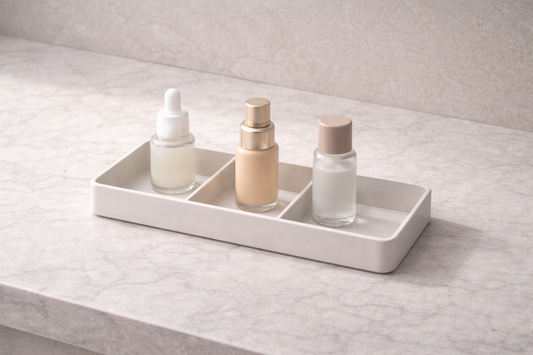 Three skincare bottles placed in separate compartments with visible gaps and one empty section showing airflow spacing and stability