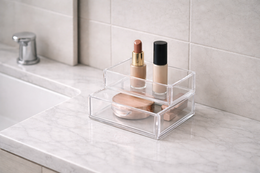 Small makeup items arranged in a compact organizer on a narrow vanity top.