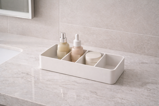 Skincare items placed in separate fixed compartments with one empty section showing stable vanity storage structure