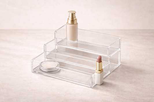 Clear acrylic tiered organizer with 2–3 items placed across levels for improved visibility and quick selection.