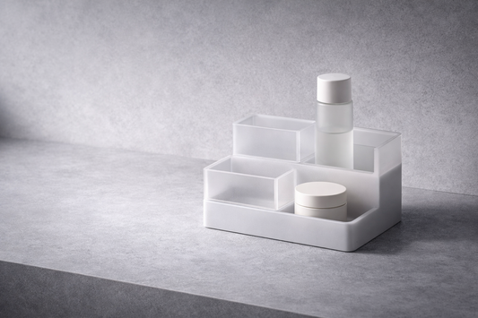 Time-saving skincare organization that improves daily flow featuring a minimalist white tiered storage shelf with frosted dividers holding a serum bottle and cream jar