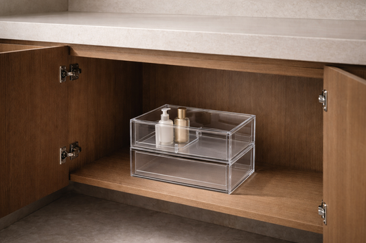 Clear acrylic organizer inside under-vanity cabinet showing hidden storage with empty surface above and structured item placement