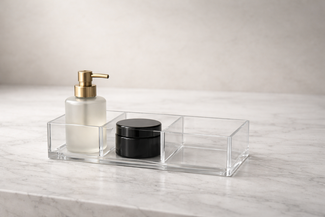 Acrylic organizer with 2 items and one empty section on a neutral surface, emphasizing efficient space use and clear layout.