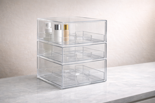 Tall skincare bottles placed vertically in a structured drawer organizer