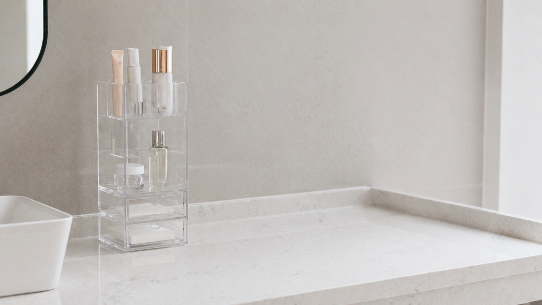Slim acrylic organizer with vertical layers and clear separation, using minimal items to optimize narrow bathroom vanity space.