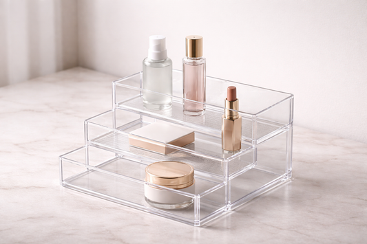 Tiered acrylic organizer with 3 items spaced across layers for improved visual scanning and layered visibility