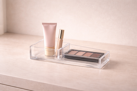 When storage finally makes sense featuring a clear acrylic divider with a gold-capped cream jar and lipstick on a neutral surface